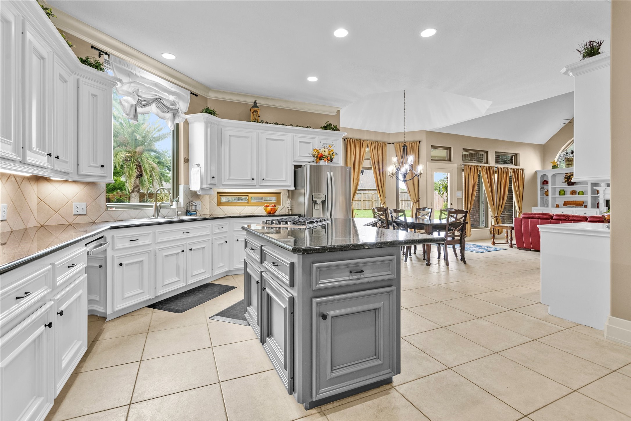 8314 Drew Haven Lane Spring, TX 77379 - Photo 14 of 49 The kitchen opens into a dining area with large windows and a view of the backyard, creating a seamless flow for entertaining.