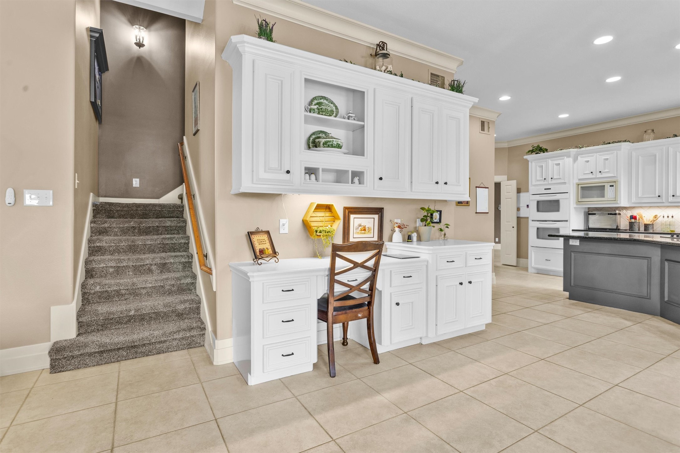 8314 Drew Haven Lane Spring, TX 77379 - Photo 19 of 49 Just off the kitchen is a built-in desk and the second set of staircases.