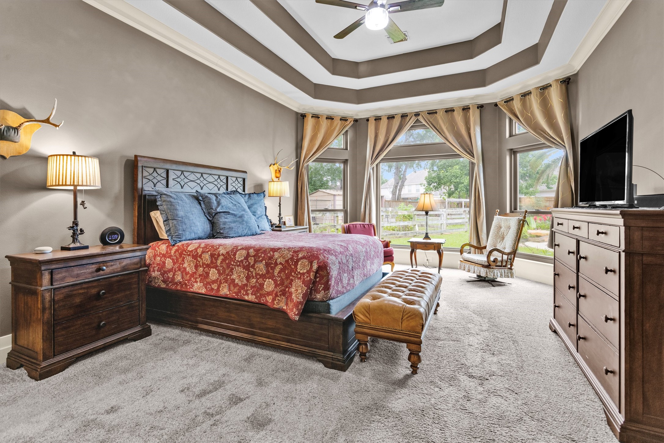 8314 Drew Haven Lane Spring, TX 77379 - Photo 22 of 49 This spacious bedroom features a tray ceiling and large windows with a cozy sitting area.