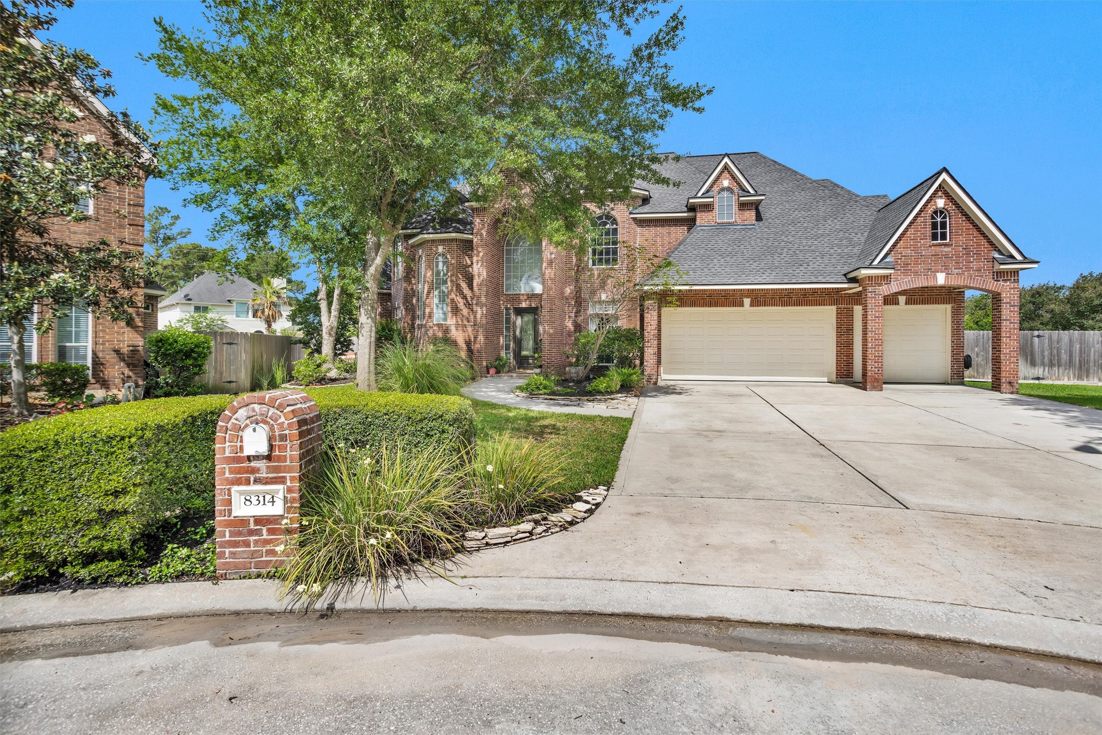 8314 Drew Haven Lane Spring, TX 77379 - Photo 3 of 49 This two-story brick home features a large driveway and three-car garage.