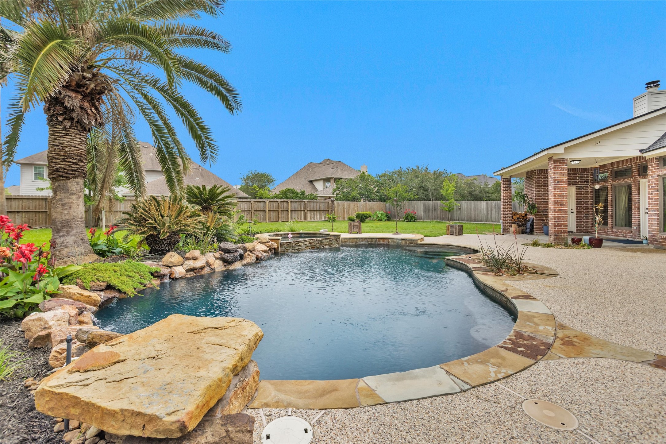 8314 Drew Haven Lane Spring, TX 77379 - Photo 43 of 49 Stone accents and lush landscaping throughout the backyard.