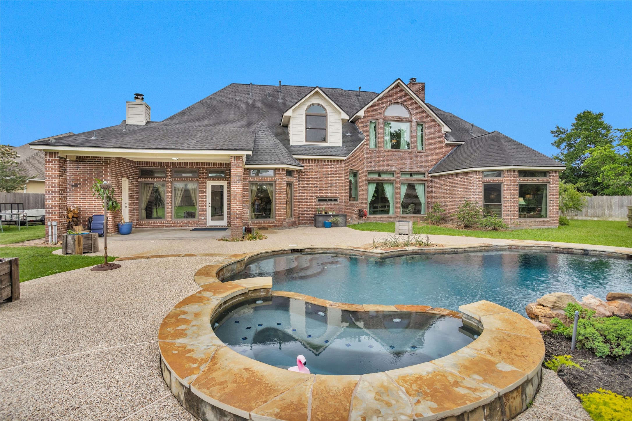 8314 Drew Haven Lane Spring, TX 77379 - Photo 45 of 49 All of the large windows provide the perfect backdrop for the pool and spa.