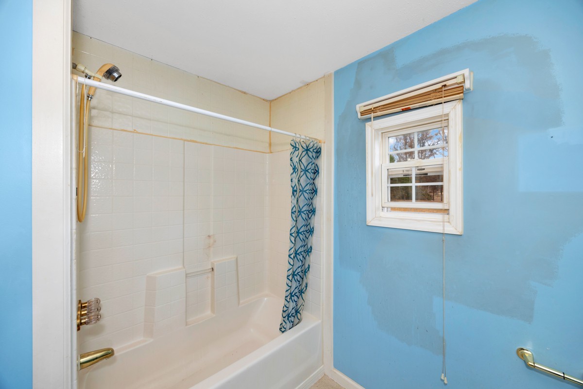 560 Old Poplar School Road Prospect, TN 38477 - Photo 11 of 28 a bathroom with a shower curtain and a window