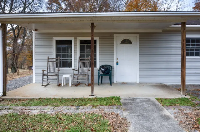 a backyard of a house with table and chairs