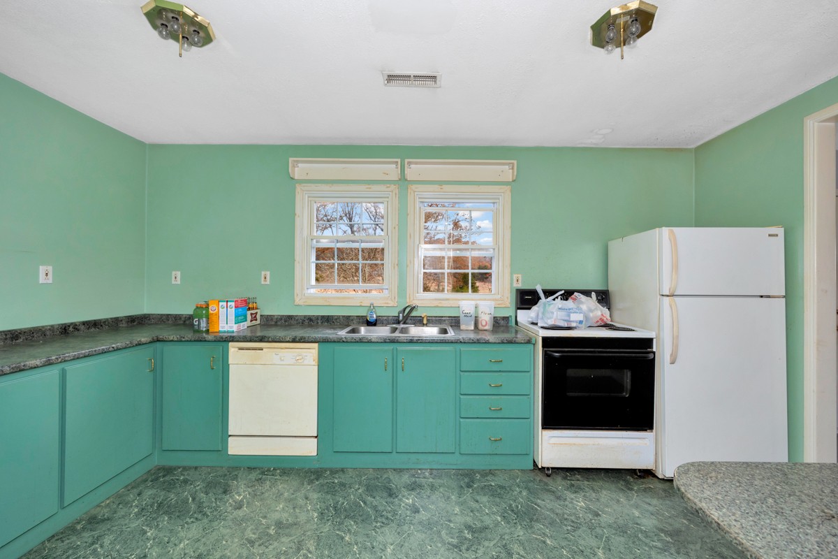 560 Old Poplar School Road Prospect, TN 38477 - Photo 6 of 28 a kitchen with a refrigerator and a sink