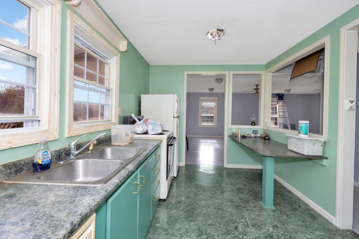 560 Old Poplar School Road Prospect, TN 38477 - Photo 7 of 28 a kitchen with kitchen island granite countertop a sink and a refrigerator