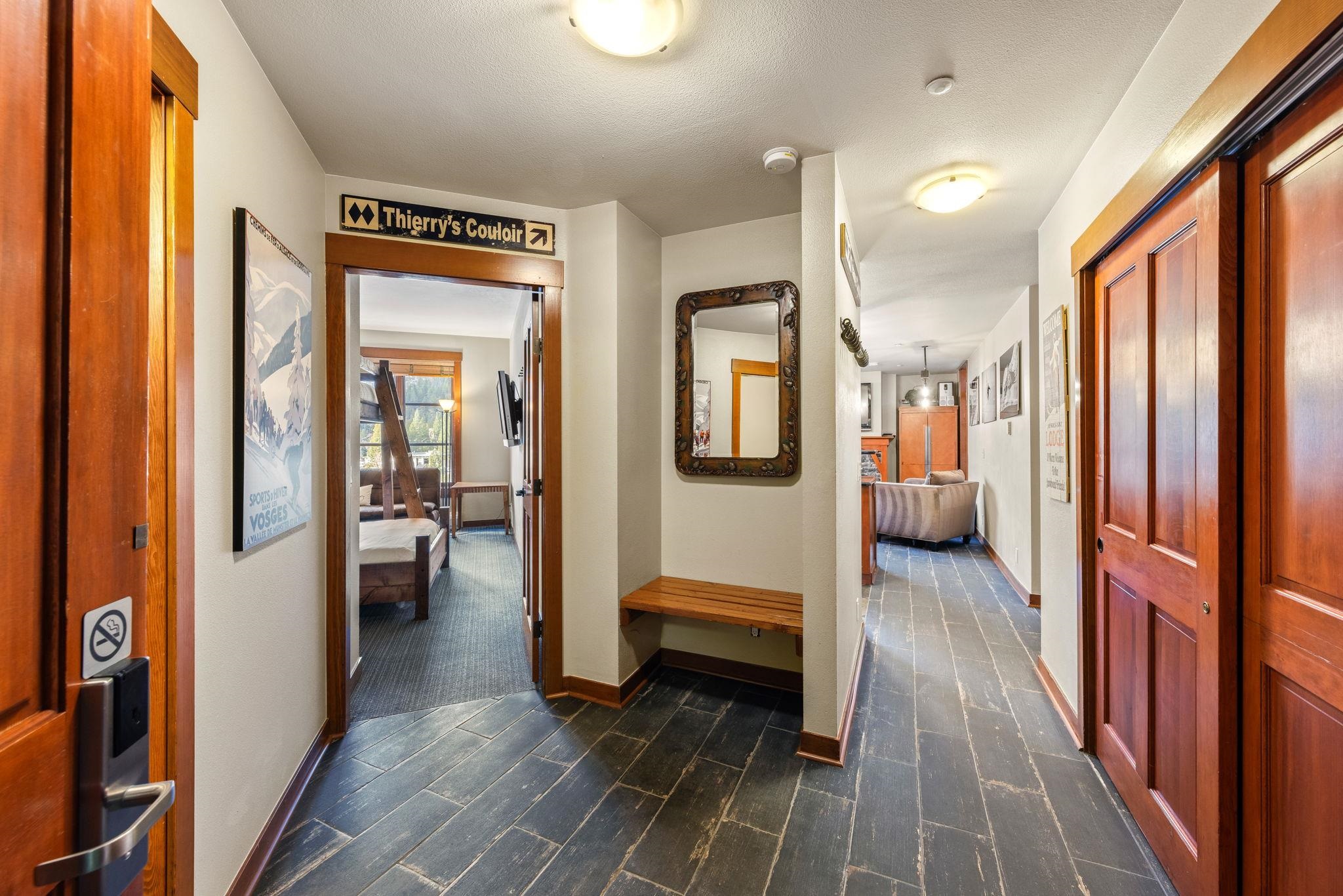 a view of a hallway with a livingroom and furniture