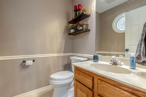 a bathroom with a sink vanity and toilet