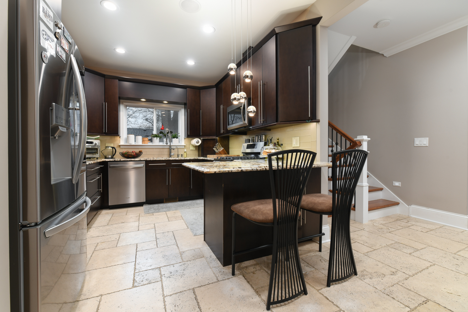 111 Grace Lane Fox River Grove, IL 60021 - Photo 12 of 33 a kitchen with stainless steel appliances granite countertop a sink a stove a table and chairs