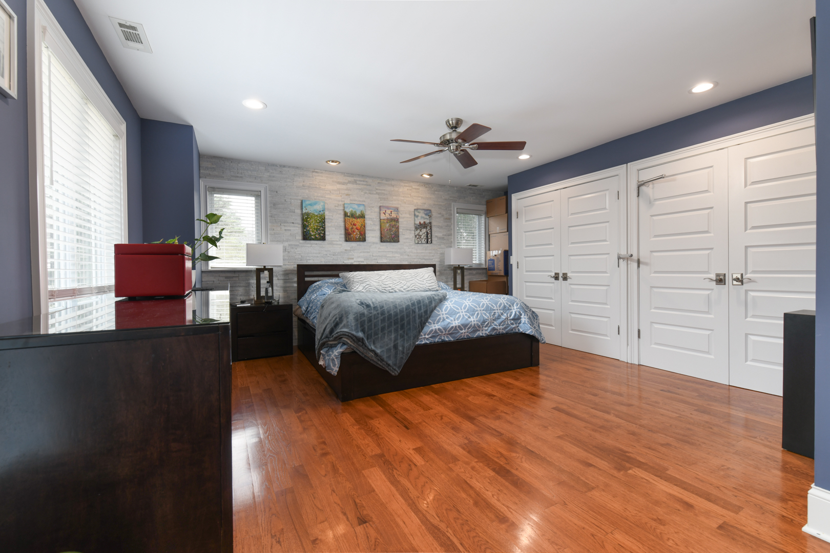 111 Grace Lane Fox River Grove, IL 60021 - Photo 17 of 33 a spacious bedroom with a large bed and a chandelier