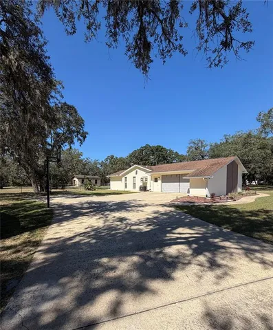 a view of a yard with wooden fence