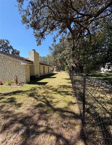 a view of a yard with wooden fence