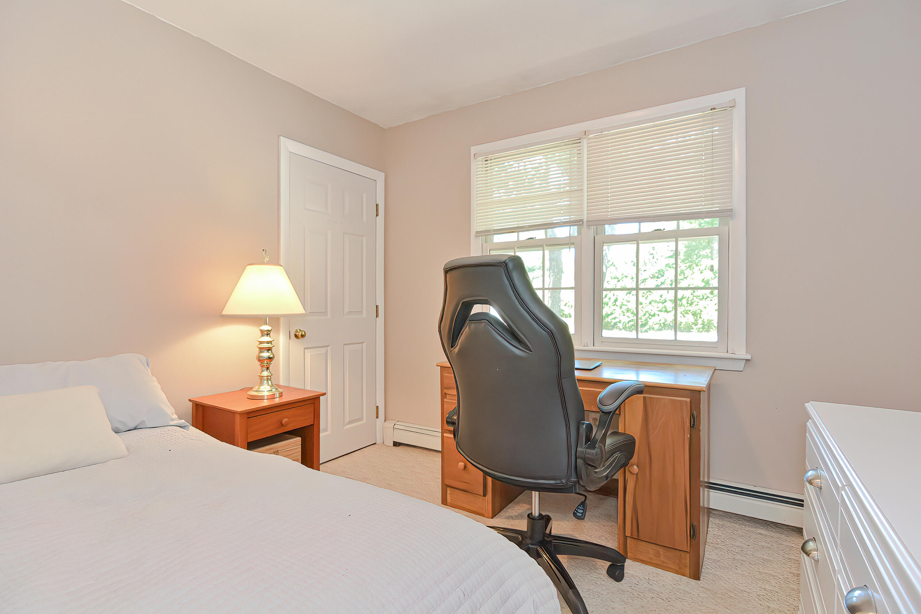 2 King Arthurs Way Buzzards Bay, MA 02532 - Photo 13 of 29 a bedroom with a bed a table and chair next to a window