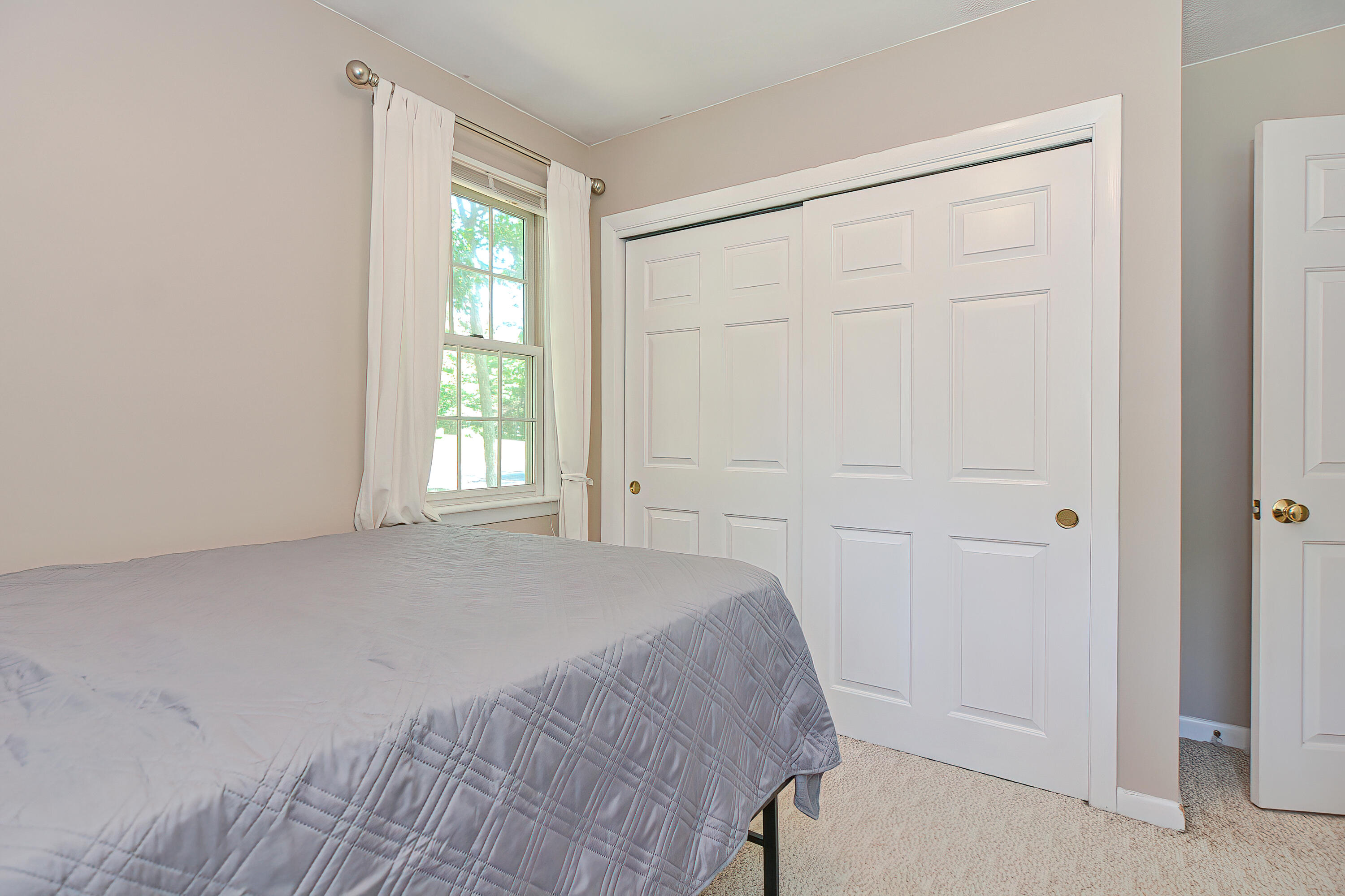 2 King Arthurs Way Buzzards Bay, MA 02532 - Photo 15 of 29 a view of a bedroom with wooden floor and window