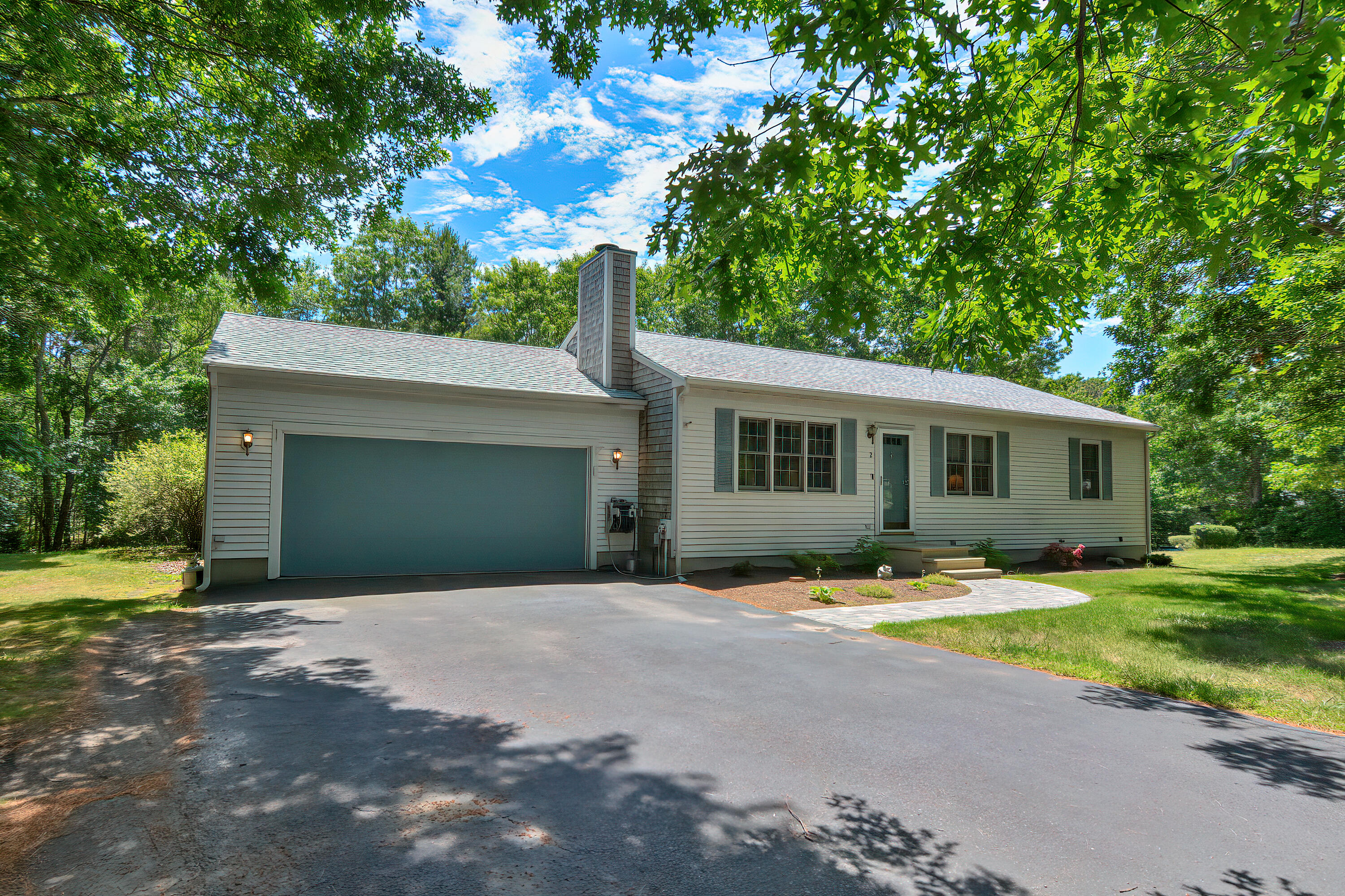 2 King Arthurs Way Buzzards Bay, MA 02532 - Photo 2 of 29 a front view of a house with a yard and garage