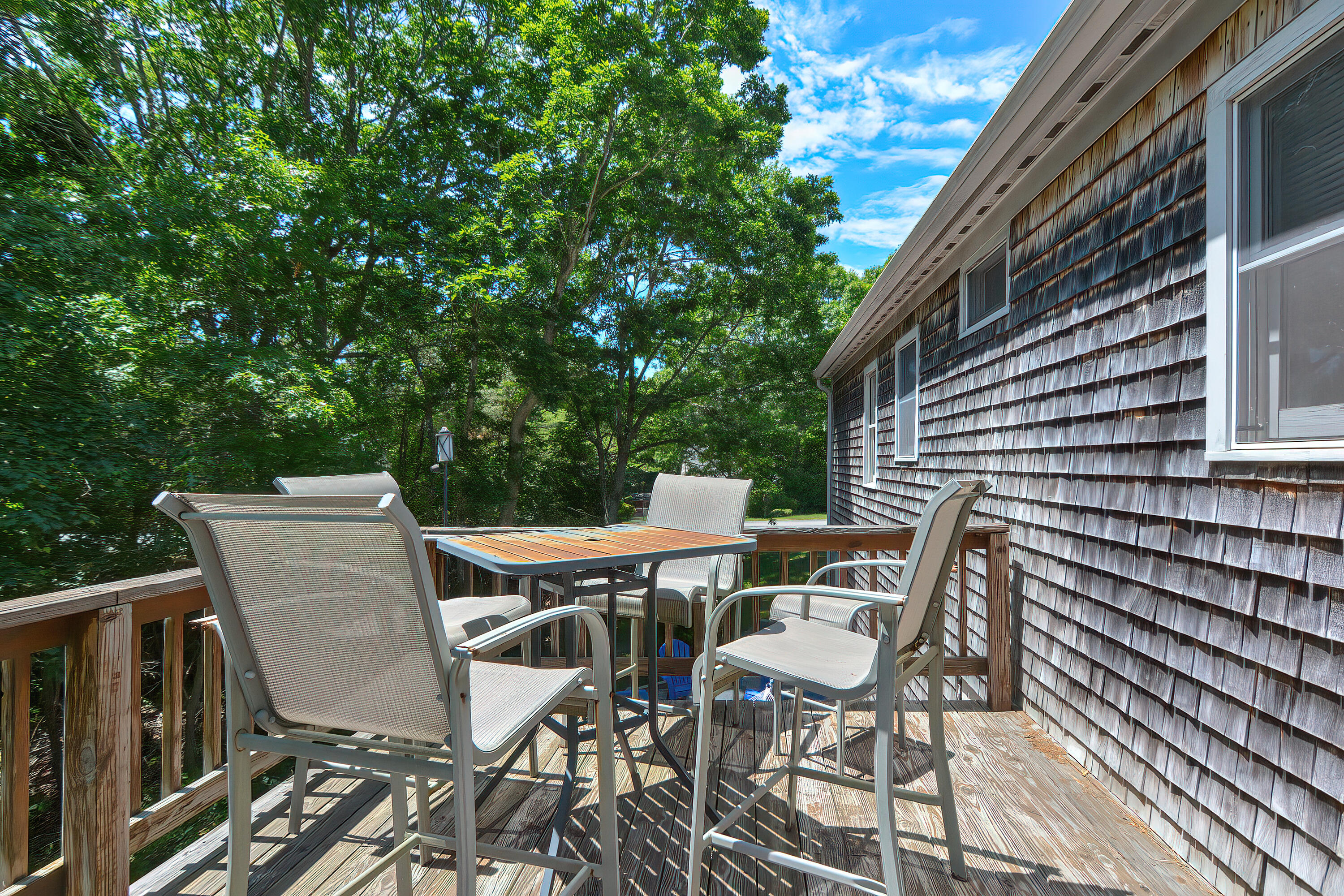 2 King Arthurs Way Buzzards Bay, MA 02532 - Photo 23 of 29 a view of a patio with table and chairs and wooden floor