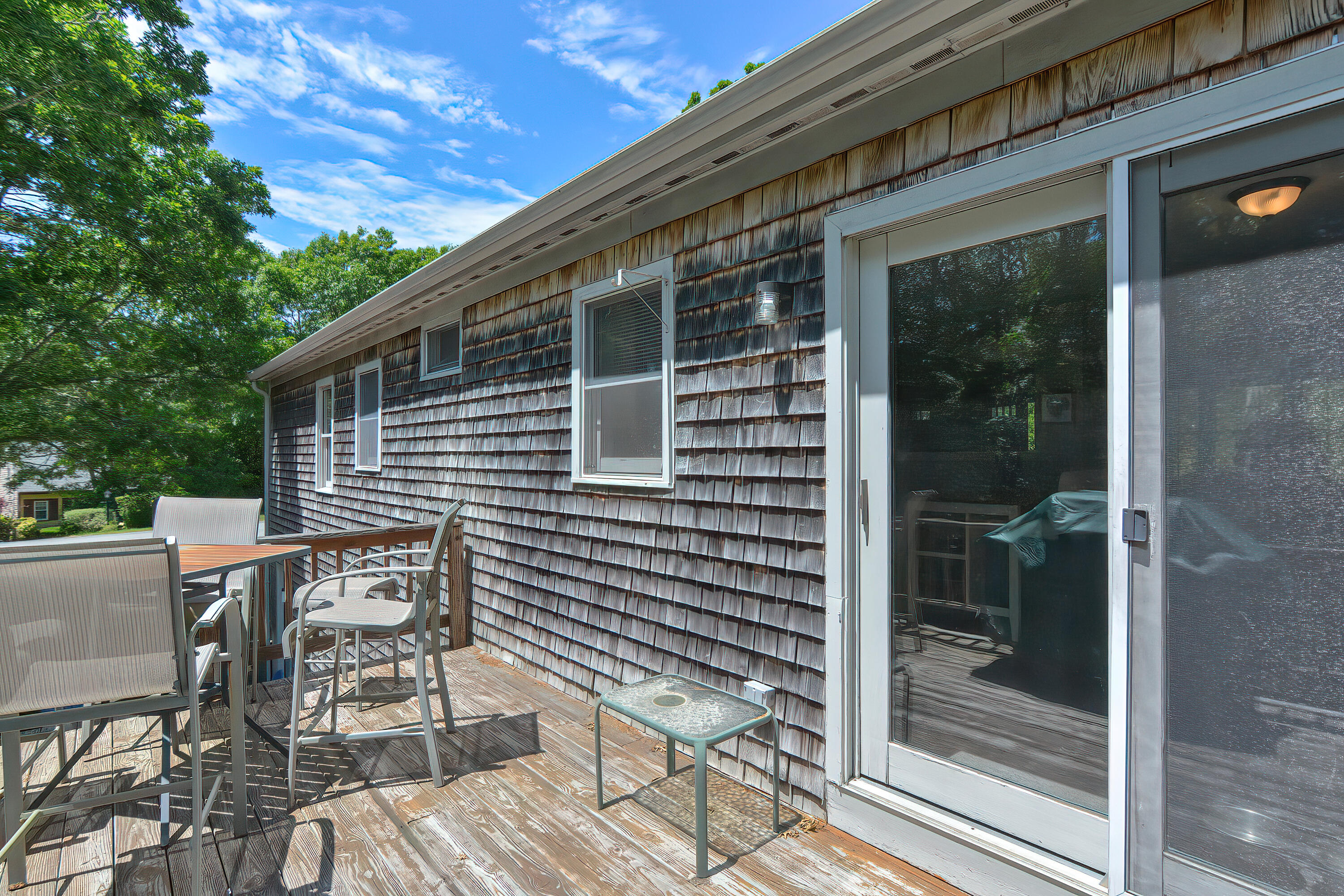 2 King Arthurs Way Buzzards Bay, MA 02532 - Photo 25 of 29 a backyard of a house with table and chairs