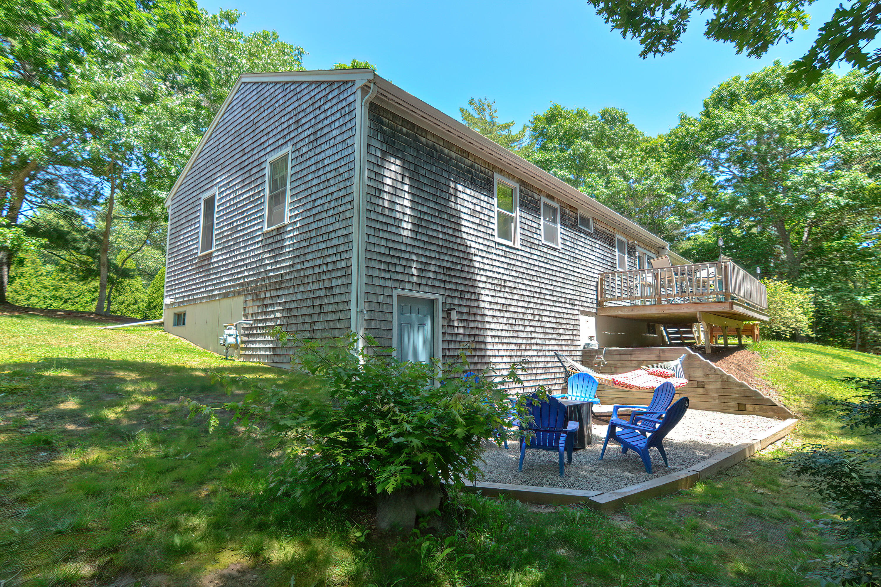 2 King Arthurs Way Buzzards Bay, MA 02532 - Photo 27 of 29 a view of a backyard with table and chairs and a slide