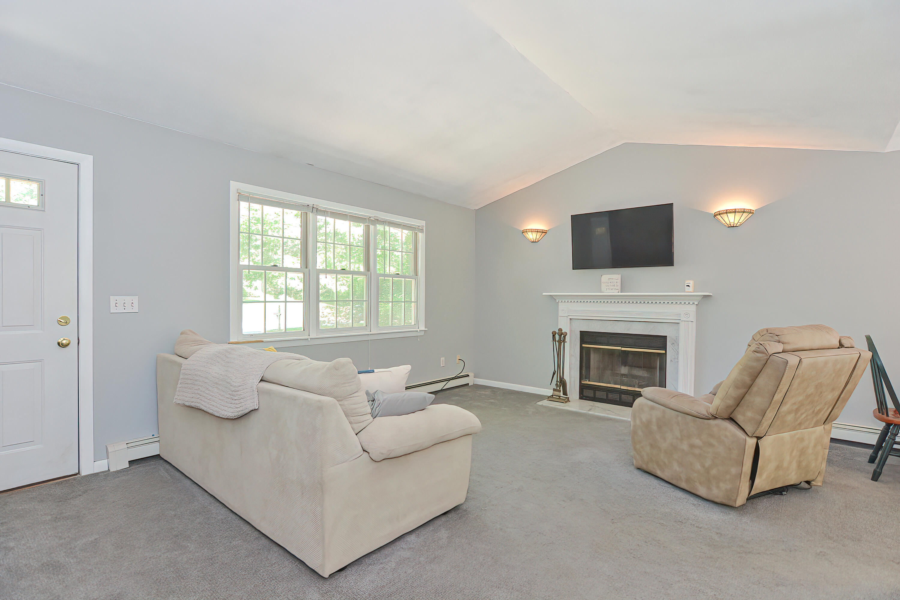 2 King Arthurs Way Buzzards Bay, MA 02532 - Photo 5 of 29 a living room with furniture a fireplace and a flat screen tv