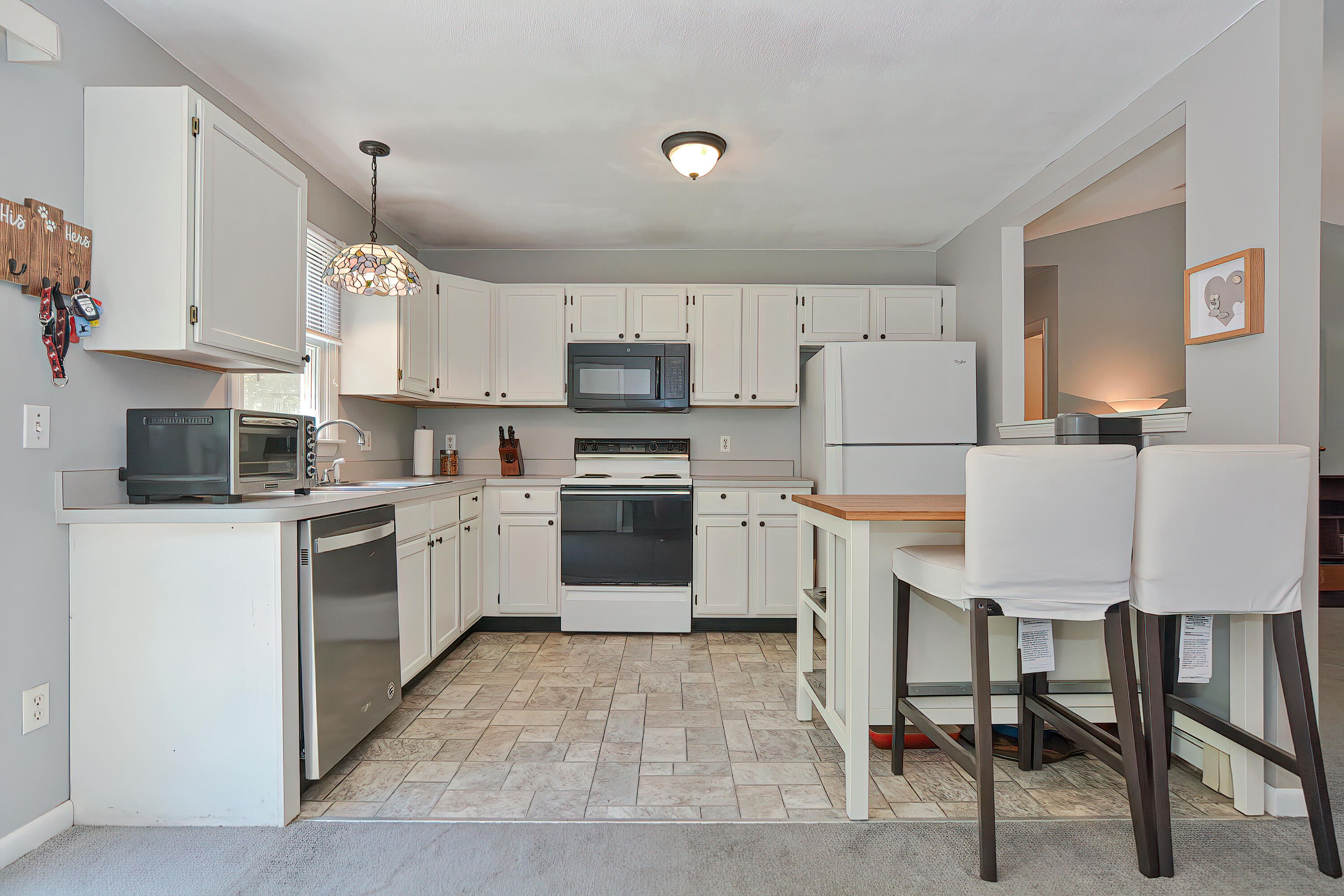 2 King Arthurs Way Buzzards Bay, MA 02532 - Photo 10 of 29 a kitchen with white cabinets and white appliances