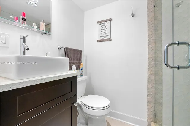 a bathroom with a sink toilet and a mirror