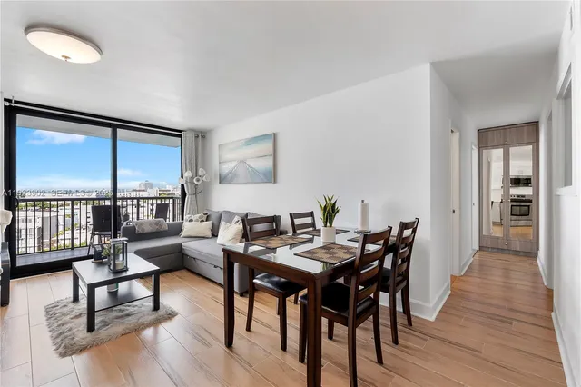 a view of a dining room with furniture window and wooden floor