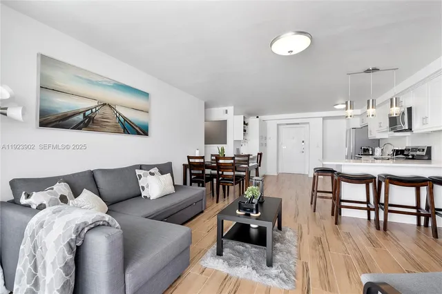 a living room with furniture and wooden floor