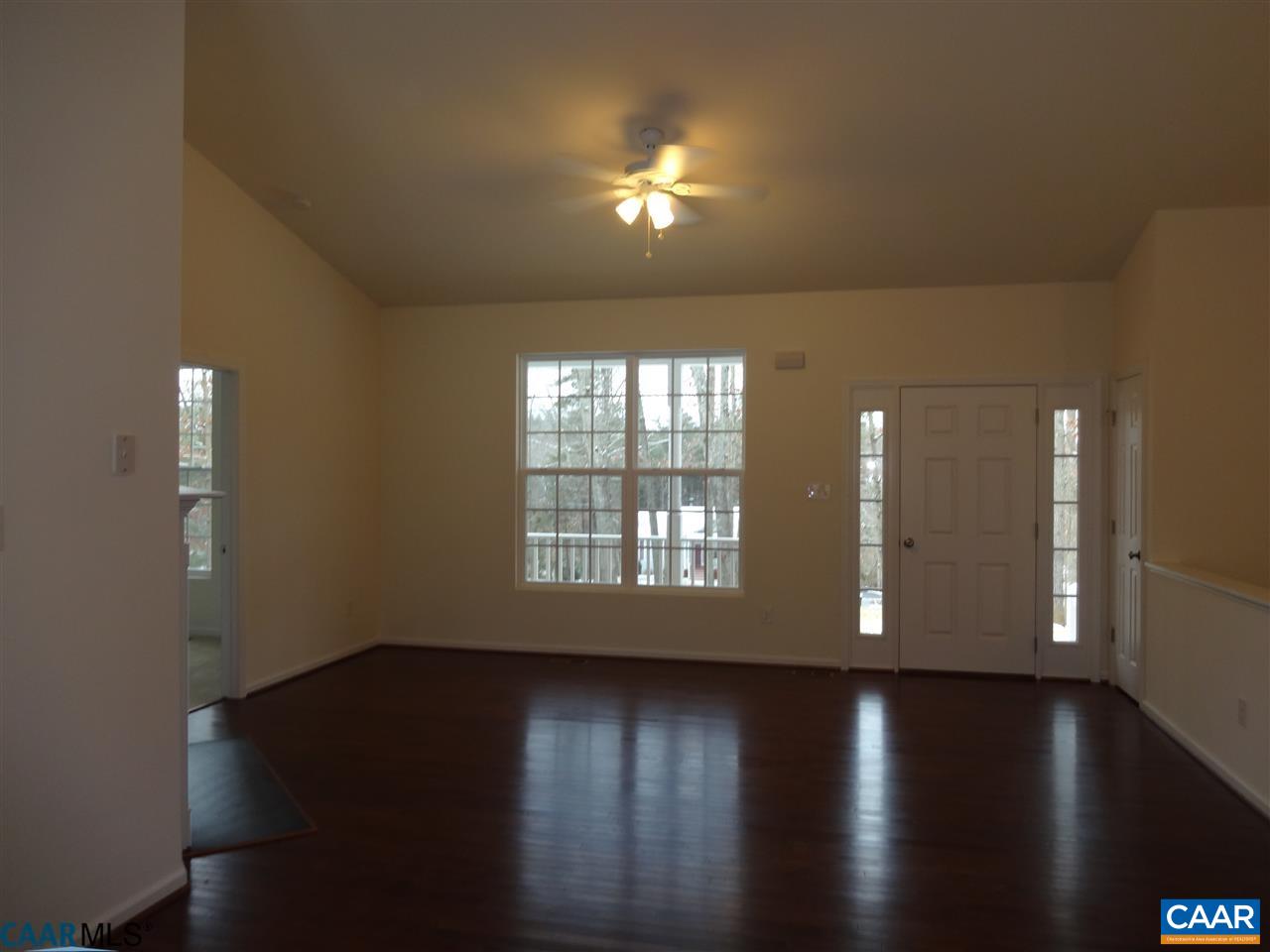 301 East Daffodil Road Ruckersville, VA 22968 - Photo 4 of 26 a view of an empty room with wooden floor and a window