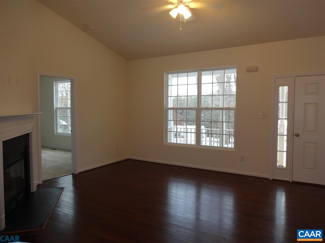 301 East Daffodil Road Ruckersville, VA 22968 - Photo 5 of 26 a view of an empty room with wooden floor and a window