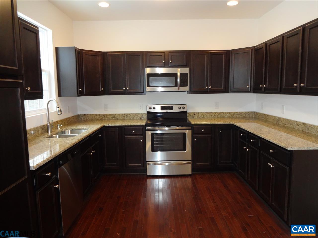 301 East Daffodil Road Ruckersville, VA 22968 - Photo 7 of 26 a kitchen with stainless steel appliances granite countertop wooden cabinets a stove a sink and a microwave