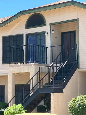 a view of a house with wooden fence
