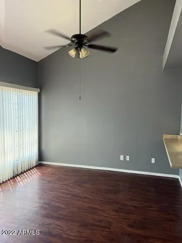 a view of a room with wooden floor