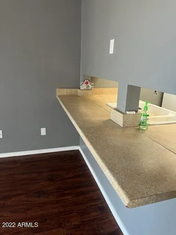 an empty room with wooden floor and a window