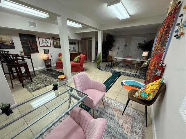 a living room with furniture a rug and white walls