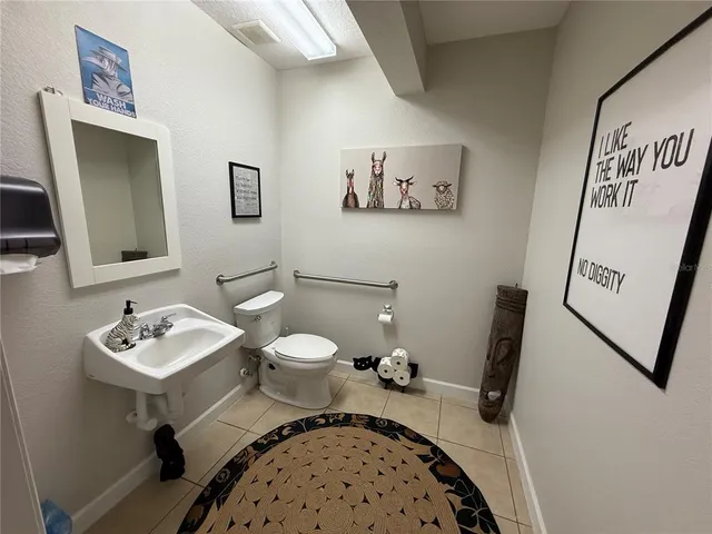 a bathroom with a sink toilet and a mirror