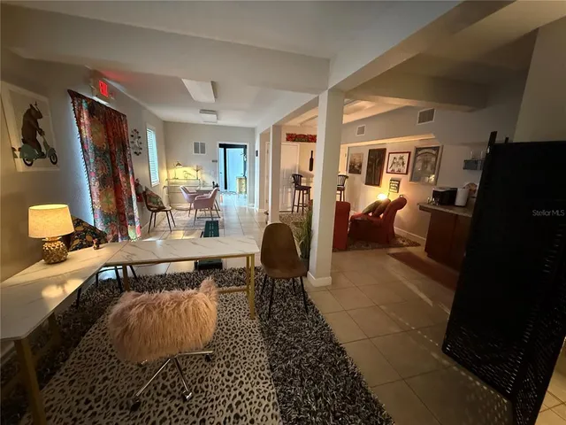 a living room with furniture rug and a large window