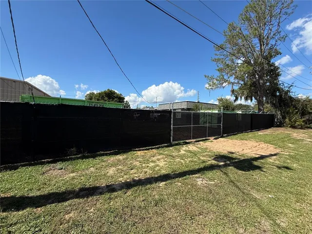 a view of backyard with wooden fence