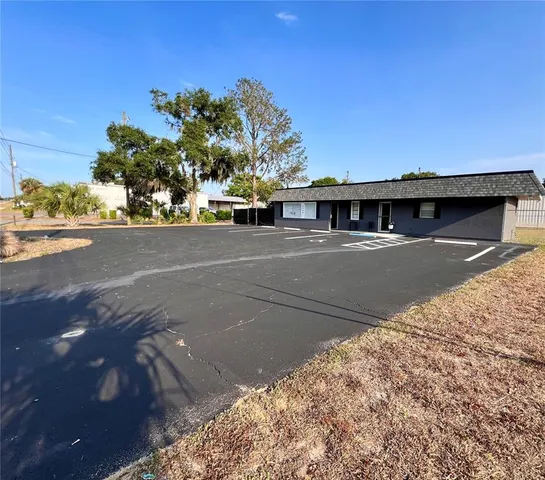 a view of street with large building in background