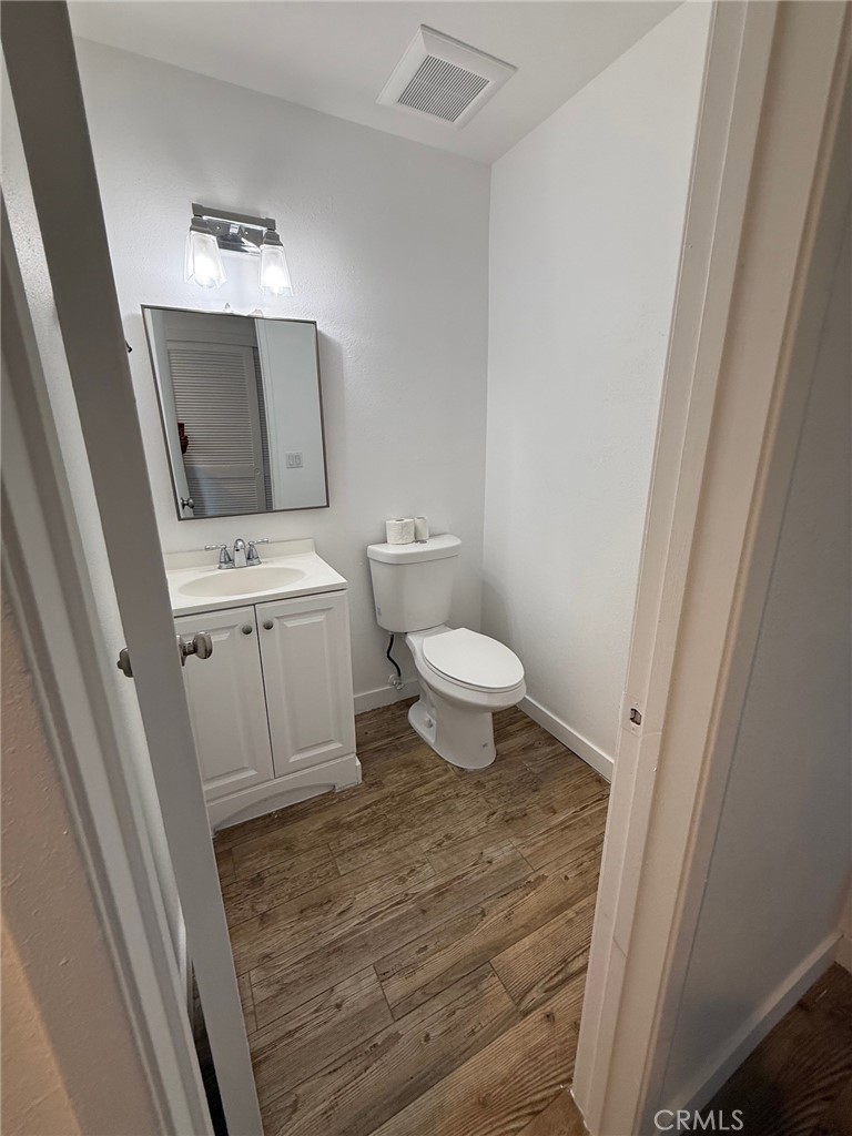 7652 Cerritos Avenue, Unit E Stanton, CA 90680 - Photo 4 of 14 a bathroom with a sink a toilet a mirror and vanity