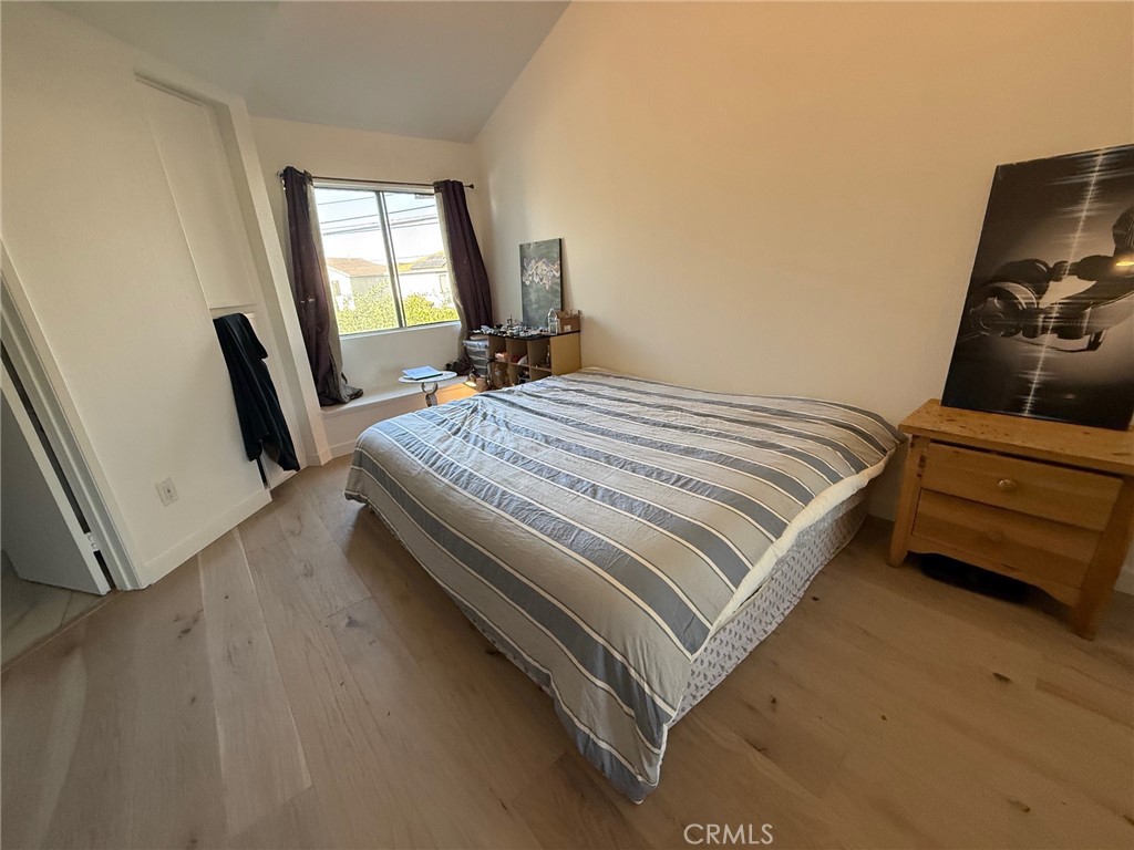 7652 Cerritos Avenue, Unit E Stanton, CA 90680 - Photo 6 of 14 a bedroom with a bed a flat screen tv and window