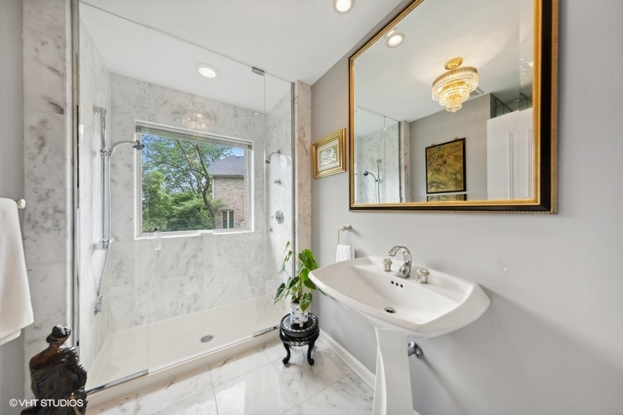 2 Keri Lane Burr Ridge, IL 60527 - Photo 12 of 24 a bathroom with a sink a bathtub and a mirror
