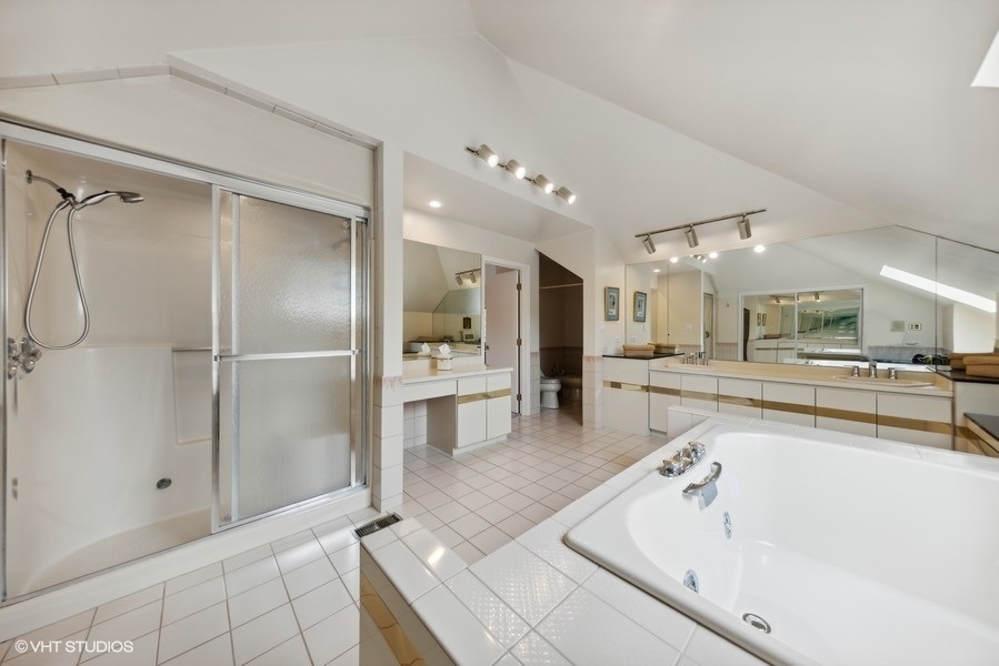 2 Keri Lane Burr Ridge, IL 60527 - Photo 19 of 24 a large white kitchen with a sink and refrigerator