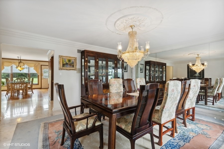 2 Keri Lane Burr Ridge, IL 60527 - Photo 3 of 24 a dining room with furniture a chandelier and wooden floor