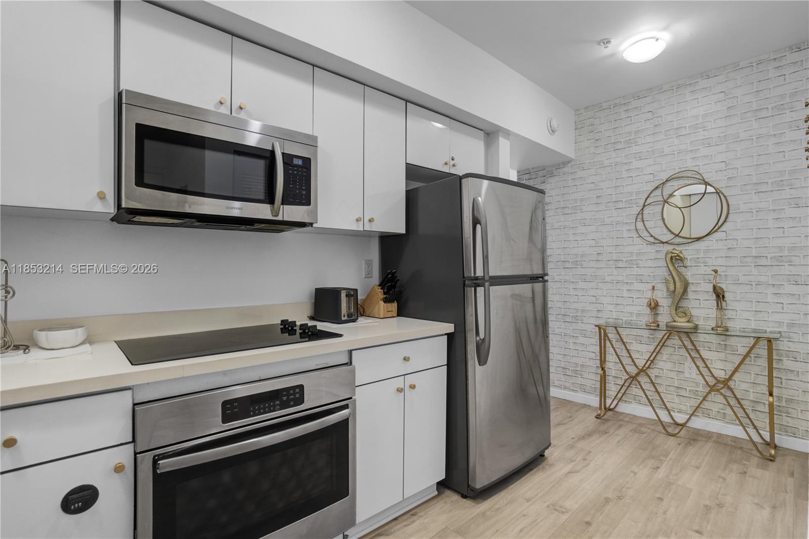 810 7th Street, Unit 107 Miami Beach, FL 33139 - Photo 11 of 36 a kitchen with a stove microwave and refrigerator