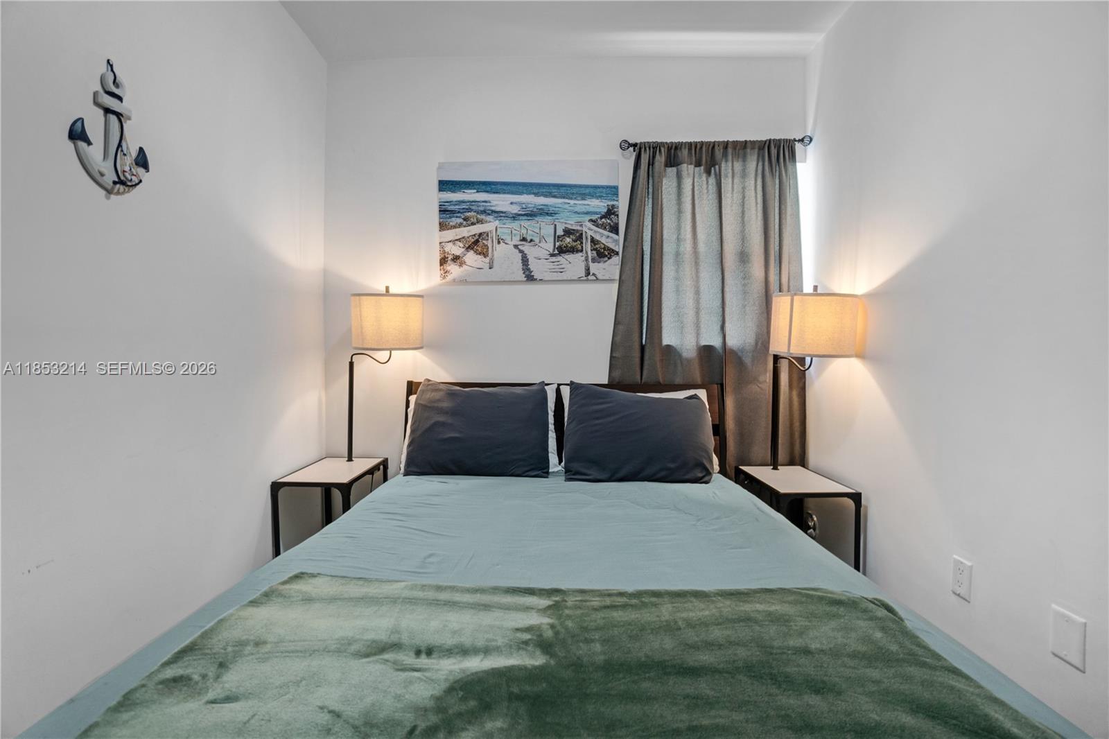 810 7th Street, Unit 107 Miami Beach, FL 33139 - Photo 18 of 36 a bed room with a bed and a night stand