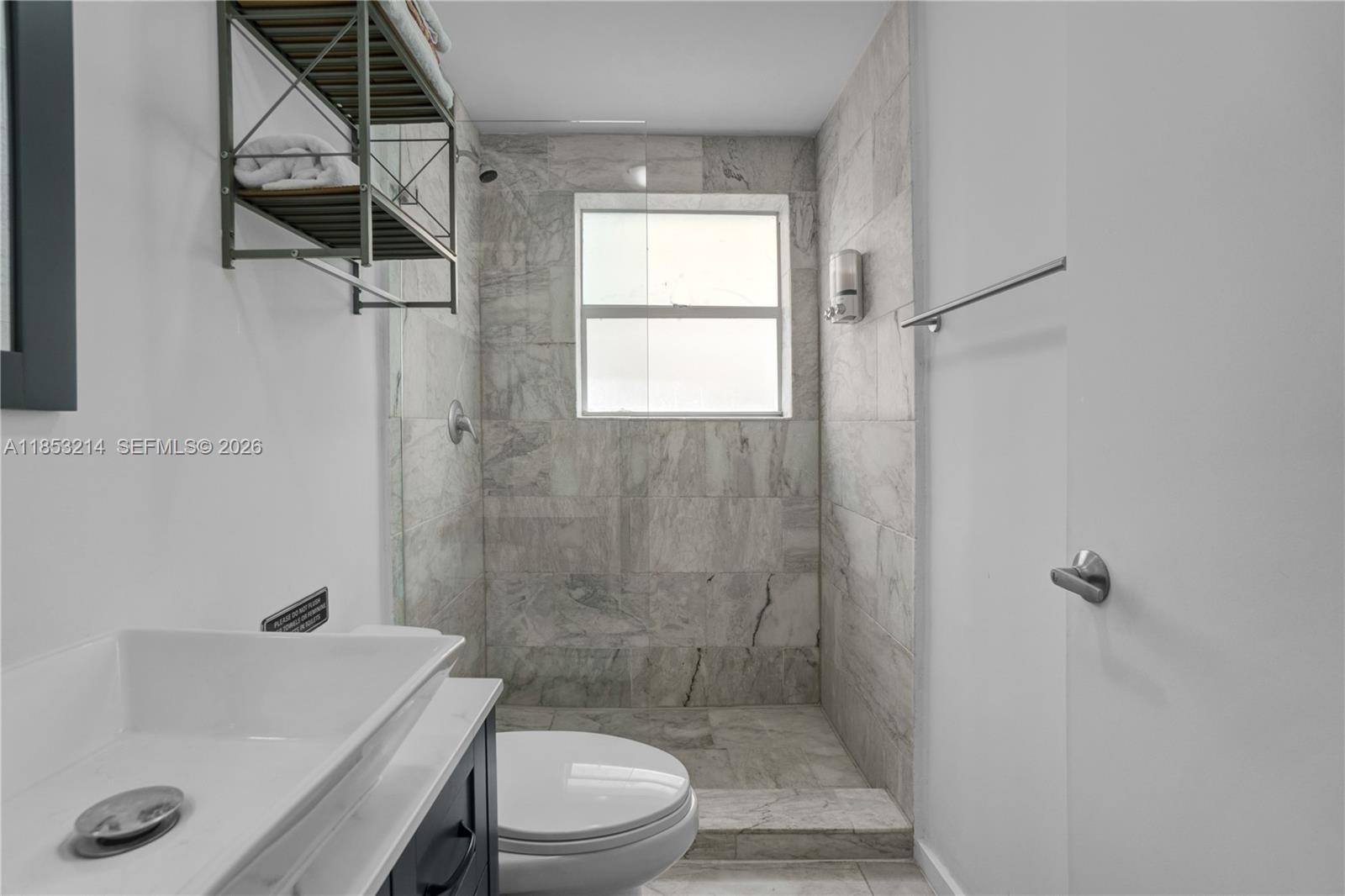 810 7th Street, Unit 107 Miami Beach, FL 33139 - Photo 20 of 36 a bathroom with a sink a toilet and shower