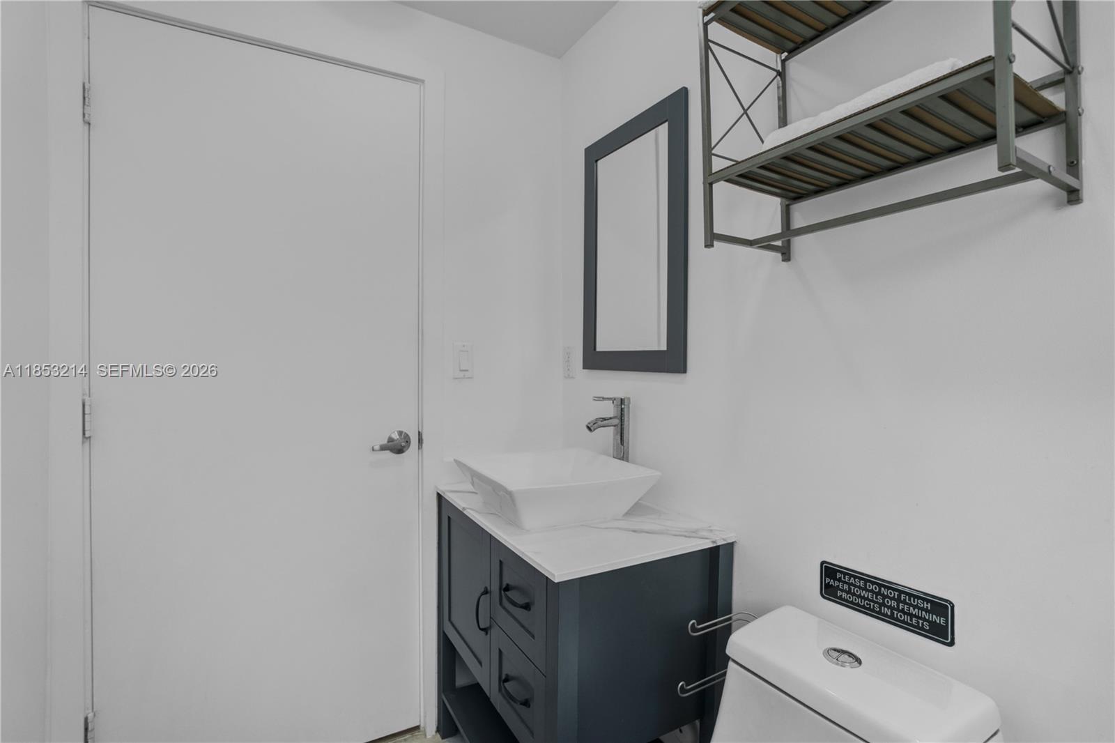 810 7th Street, Unit 107 Miami Beach, FL 33139 - Photo 21 of 36 a bathroom with a sink toilet and mirror