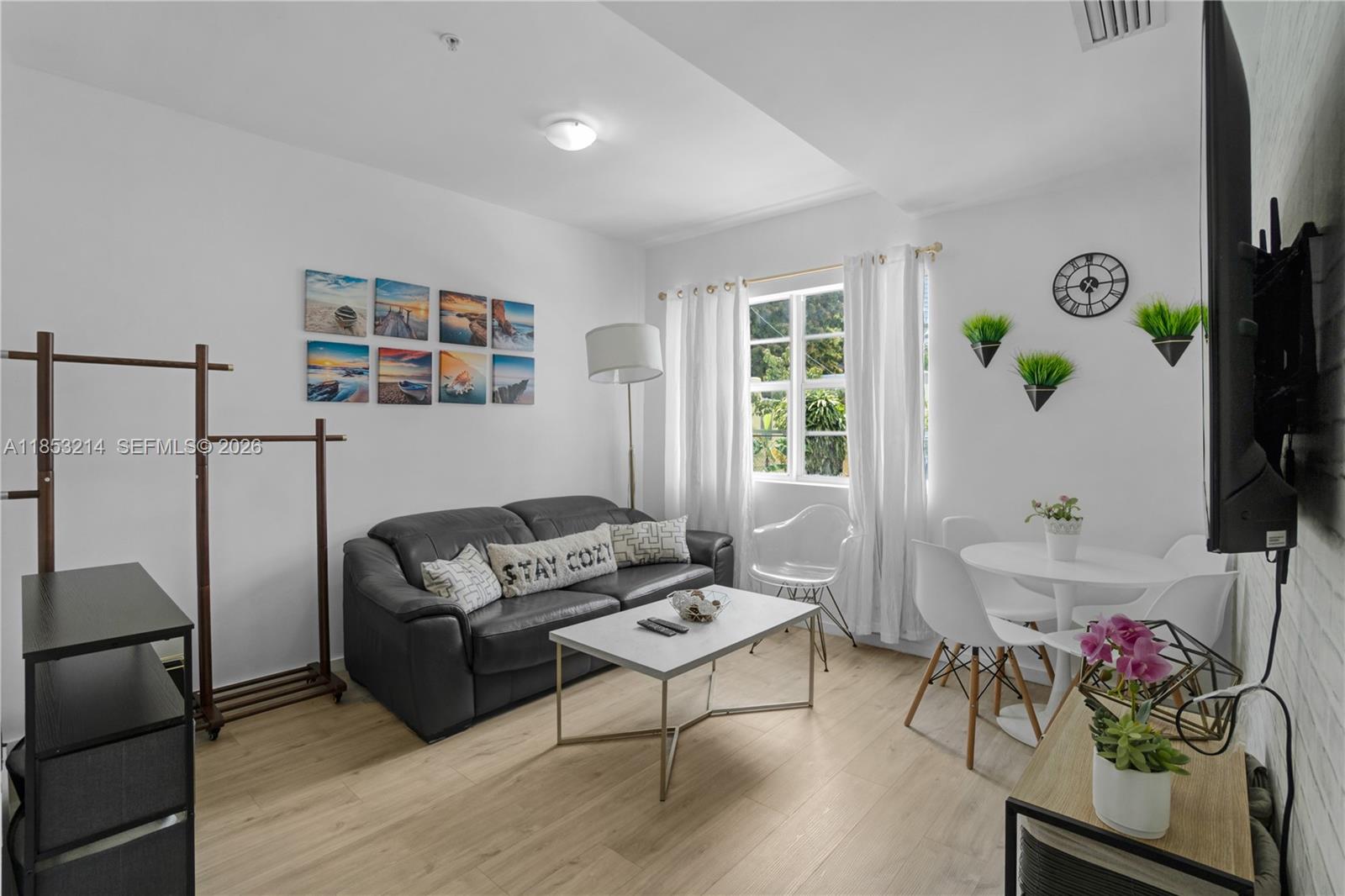 810 7th Street, Unit 107 Miami Beach, FL 33139 - Photo 22 of 36 a living room with furniture and a window