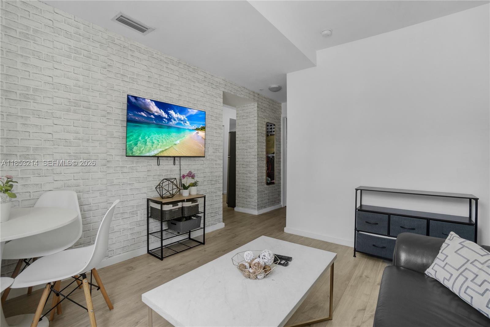 810 7th Street, Unit 107 Miami Beach, FL 33139 - Photo 23 of 36 a living room with furniture and a flat screen tv