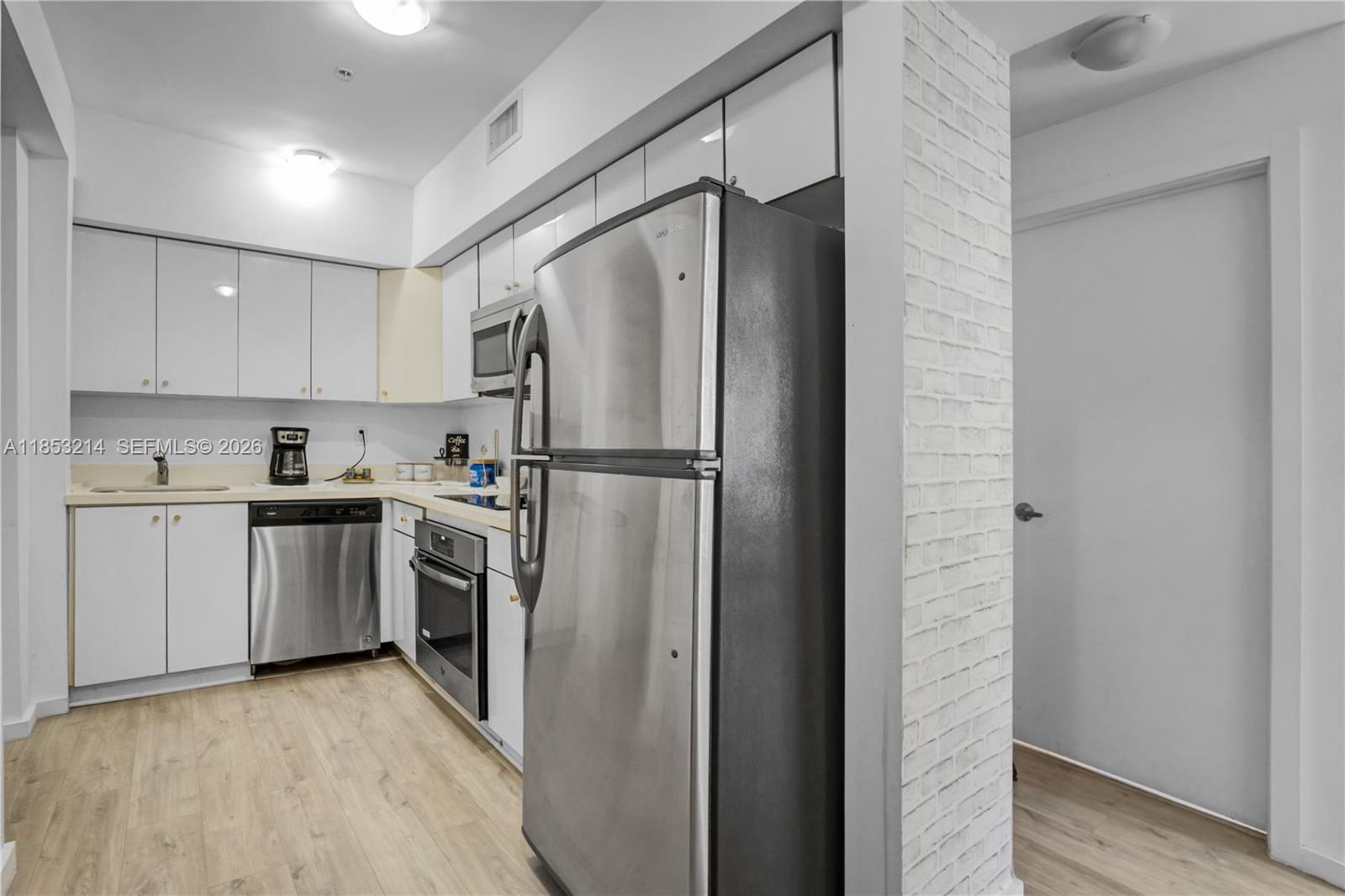 810 7th Street, Unit 107 Miami Beach, FL 33139 - Photo 8 of 36 a kitchen with a refrigerator and a sink